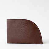 The Factory Second Made in Maine Front Pocket Wallet - BROWN by Rogue Industries, crafted from premium top grain leather, features a unique curved edge design. It offers RFID-blocking protection and is elegantly displayed closed against a plain white background.