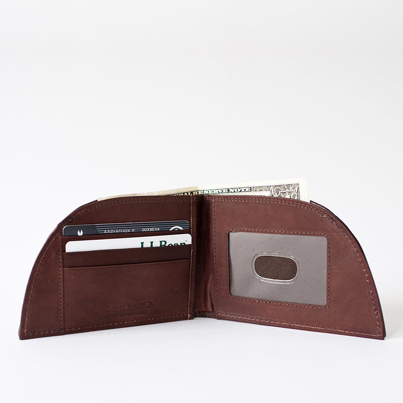 Discover the Factory Second Made in Maine Front Pocket Wallet - FOOTBALL LEATHER by Rogue Industries. This premium leather wallet boasts a minimalist design with compartments for cards, a visible one-dollar bill, and a transparent ID window.