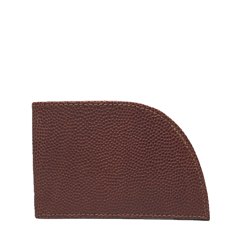 The Factory Second Made in Maine Front Pocket Wallet - FOOTBALL LEATHER by Rogue Industries is a brown minimalist wallet crafted from premium leather, featuring a distinctive curved edge on one side and offering RFID-blocking protection to ensure your cards are secure.